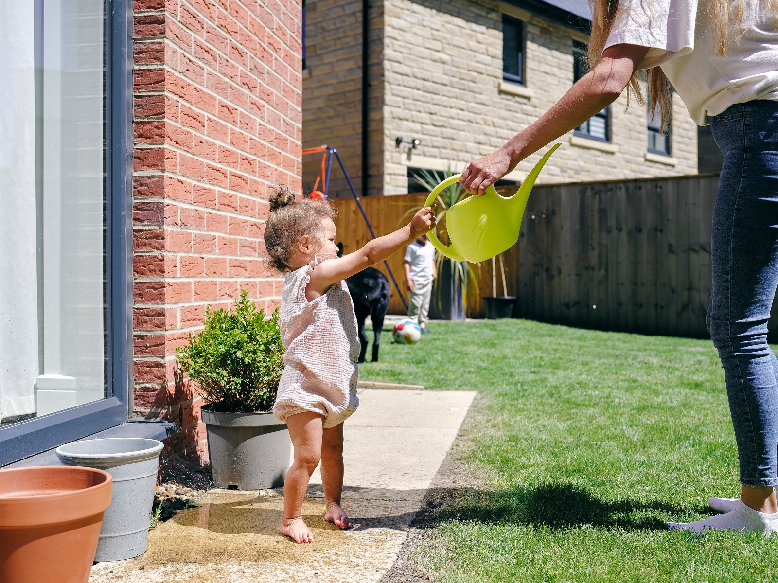 Young child with dog in the yard