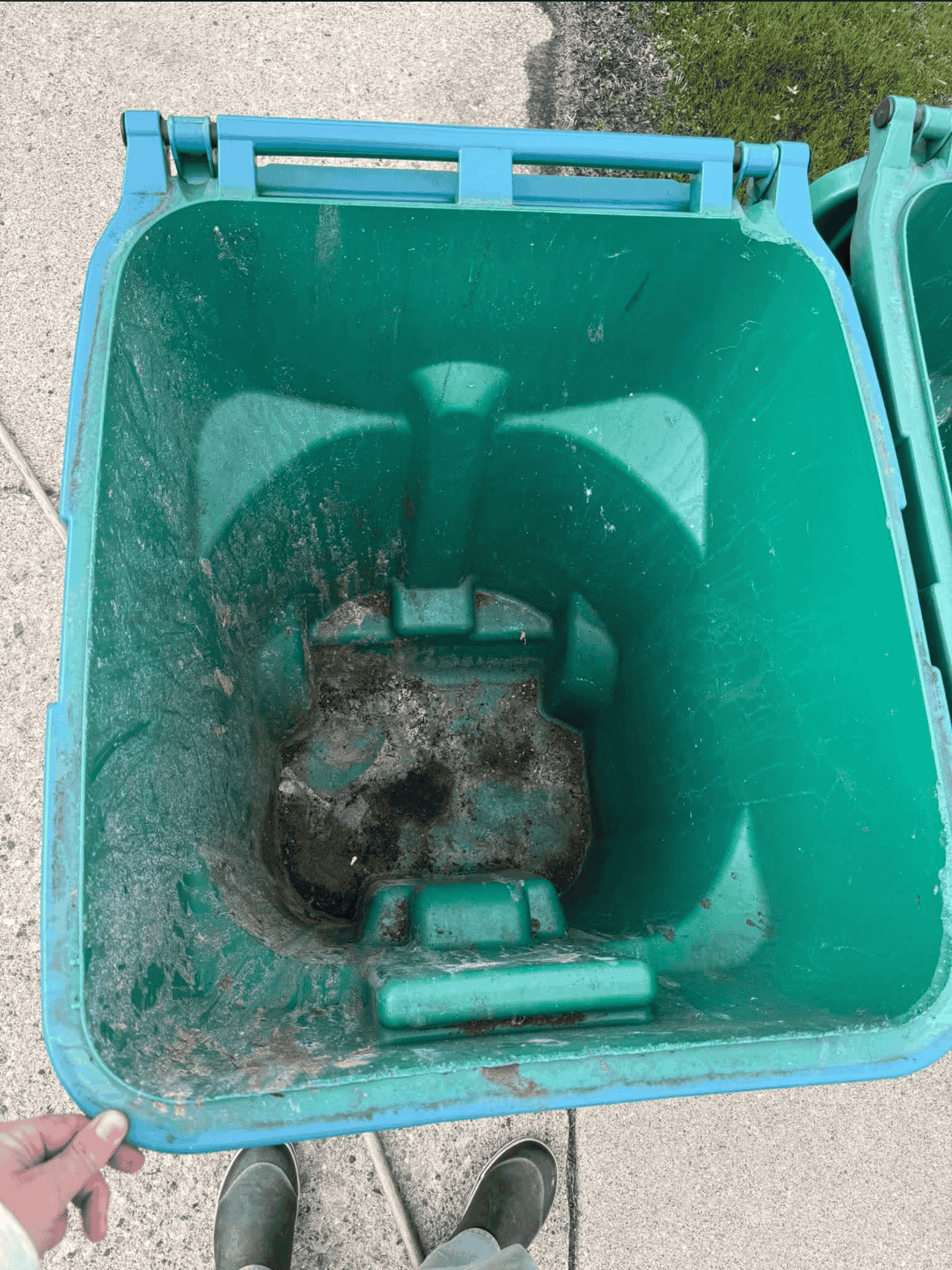 Rotting residue and liquid at the bottom of the can doesn't go away by itself. It gets worse every week.